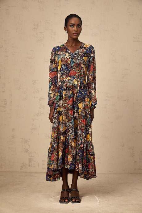 Woman wearing a brown bohemian style midi dress with shirring detail and flowing skirt