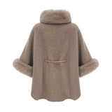 Woman wearing a brown wool cape coat with fur trim and belt cinched at the waist