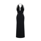 Woman wearing a fitted maxi dress with colorblocked design featuring contrasting colors and a long silhouette