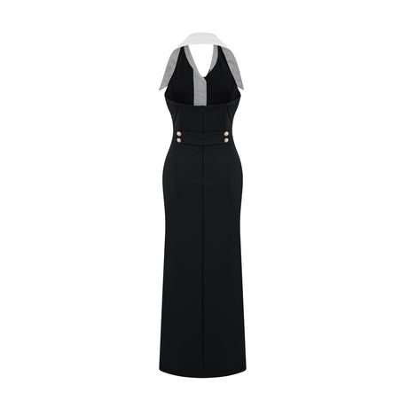 Woman wearing a fitted maxi dress with colorblocked design featuring contrasting colors and a long silhouette