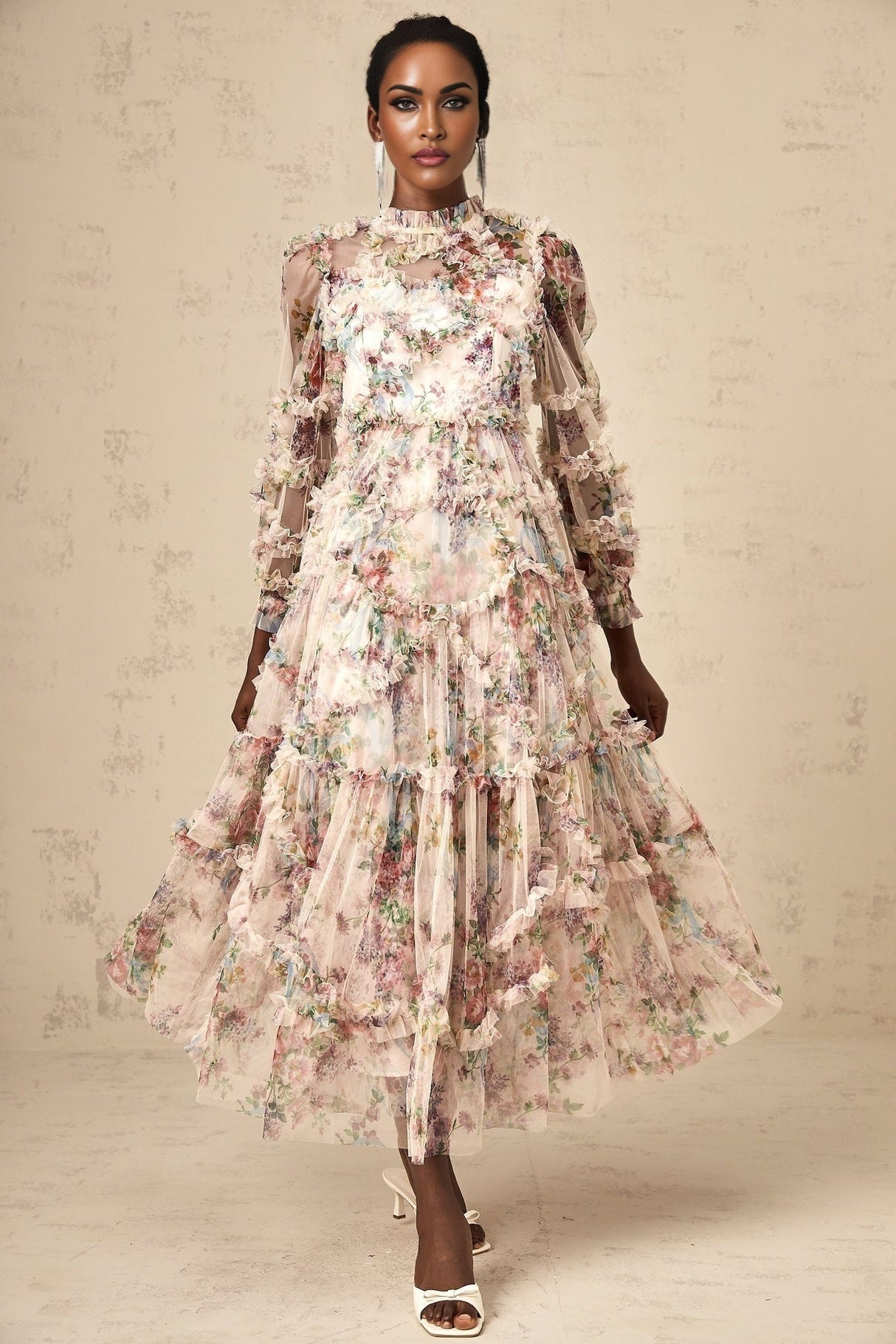 Woman wearing a floral patterned midi dress with ruffled tulle details and a feminine silhouette