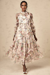 Woman wearing a floral patterned midi dress with ruffled tulle details and a feminine silhouette