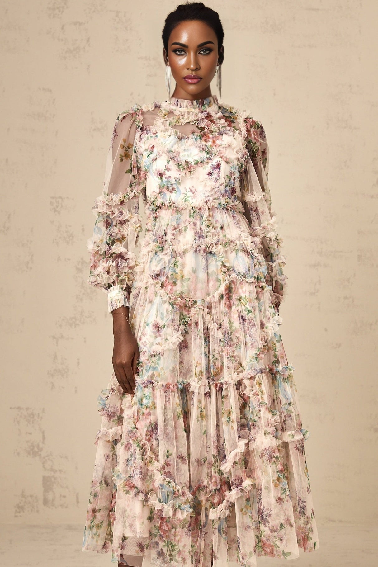 Woman wearing a floral patterned midi dress with ruffled tulle details and a fitted waist
