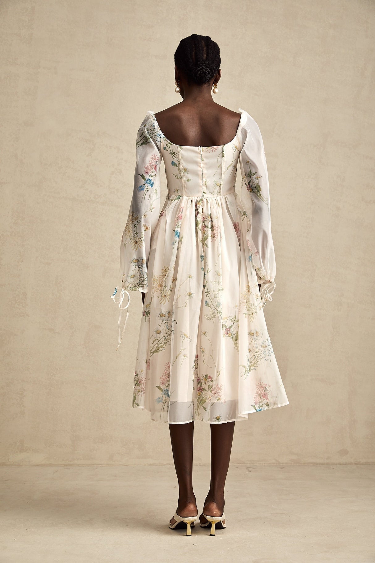 Woman wearing a floral print midi dress with square neckline and Anne design