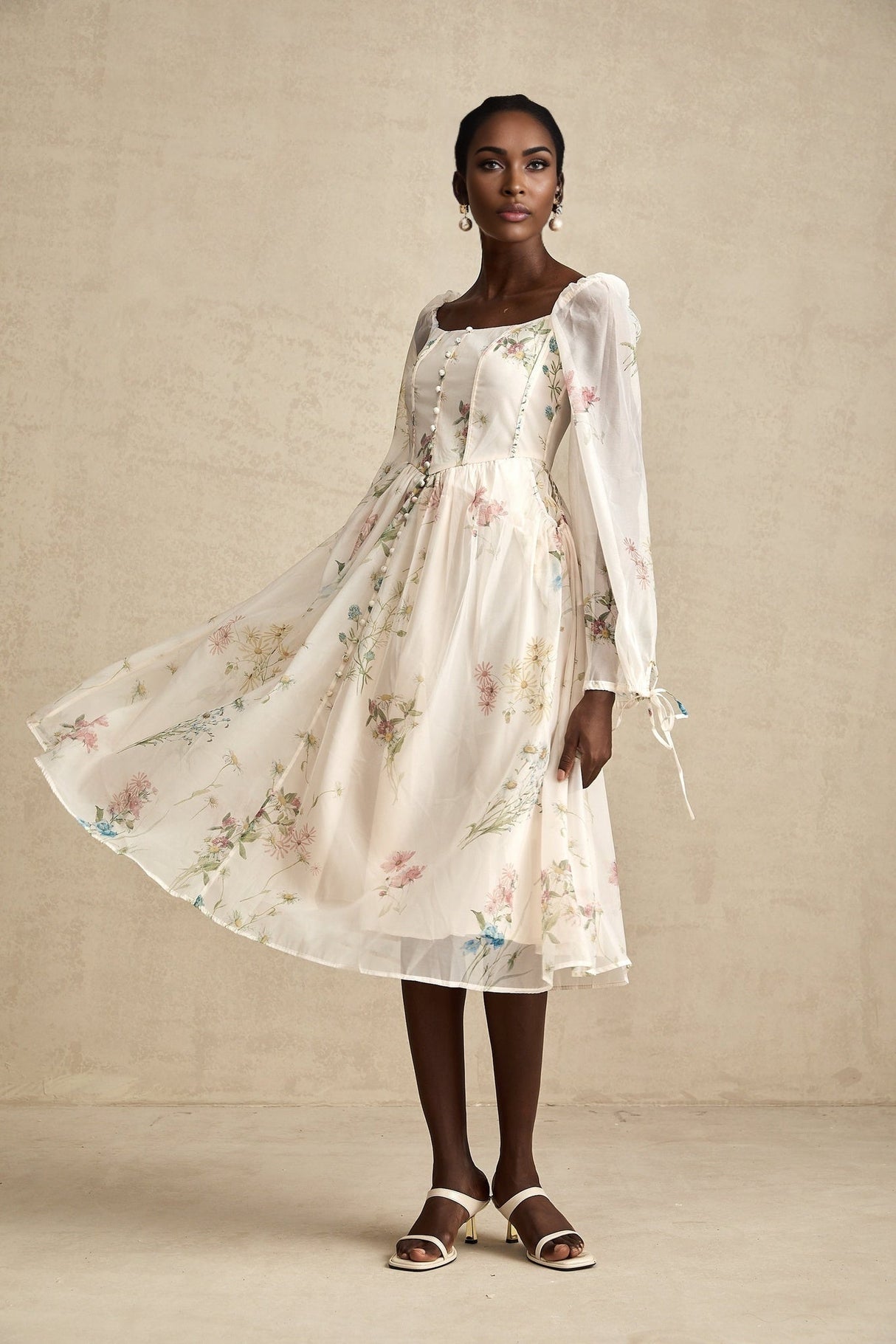 Woman wearing a floral print midi dress with square neckline and Anne design