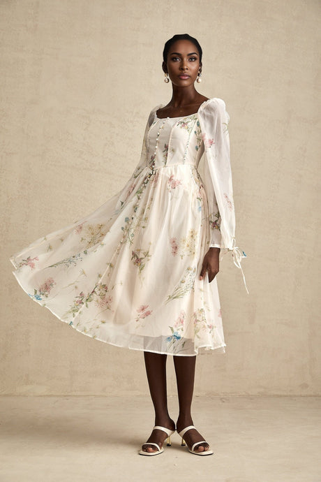 Woman wearing a floral print midi dress with square neckline and Anne design