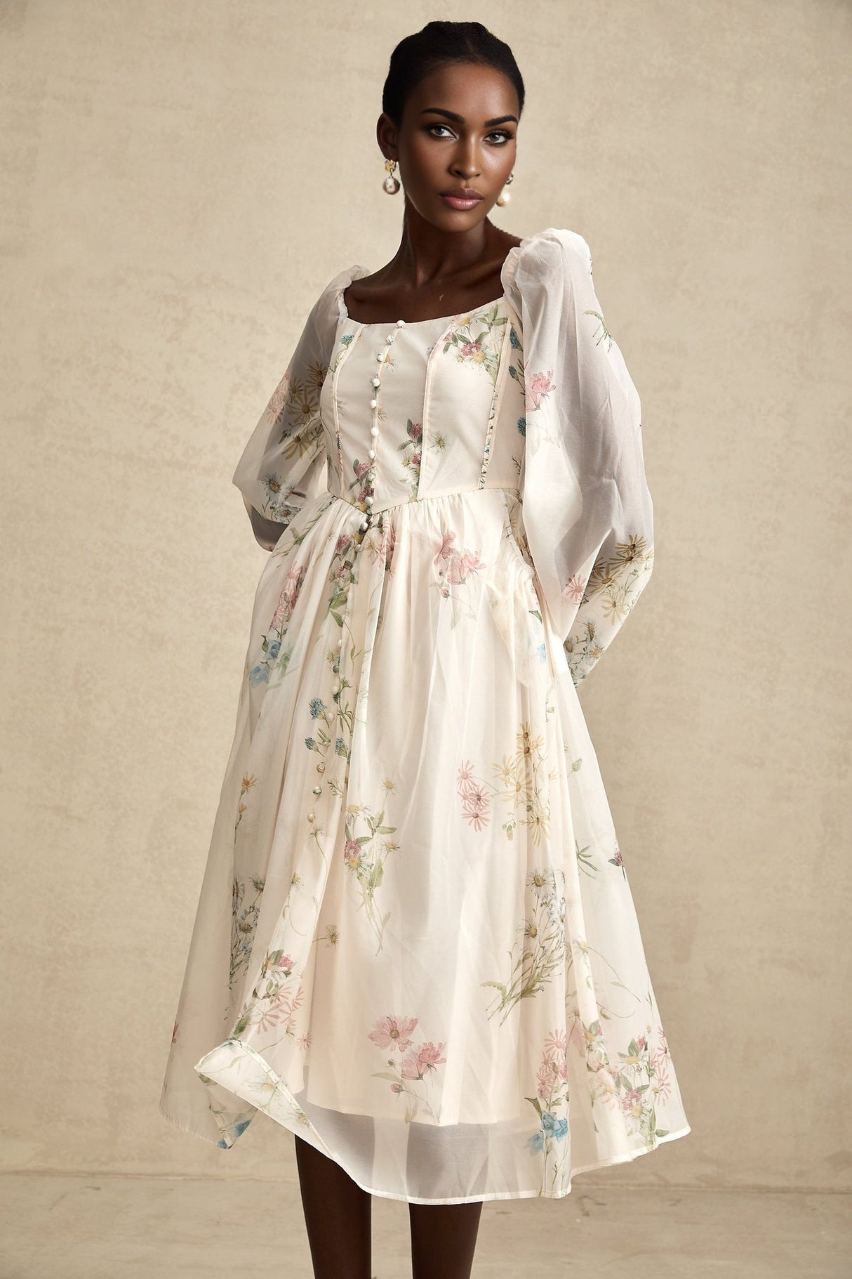 Woman wearing a floral print midi dress with square neckline named Anne