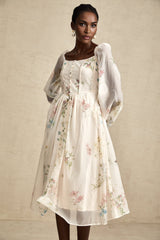 Woman wearing a floral print midi dress with square neckline named Anne