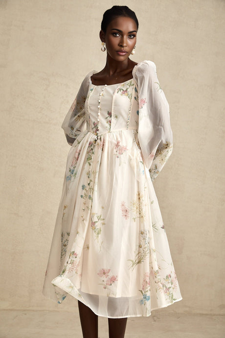 Woman wearing a floral print midi dress with square neckline named Anne
