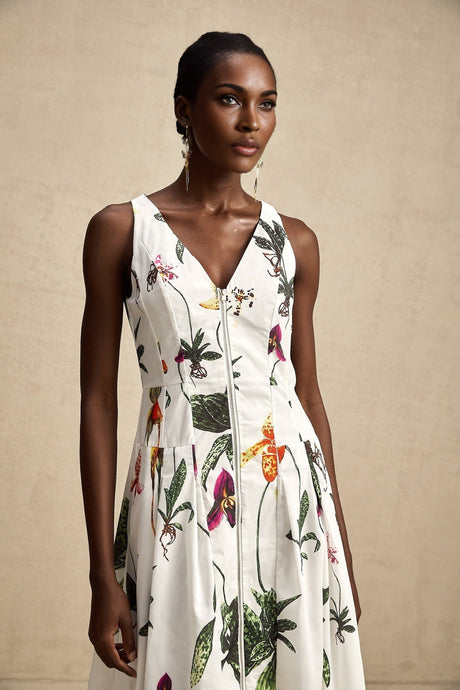 Woman wearing a floral print midi dress with vneck and poplin fabric featuring a colorful Magali design