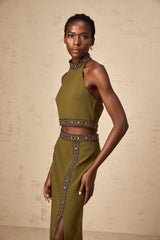 Woman wearing a green daisy patterned top and matching skirt set with beaded trim details