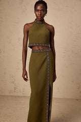 Woman wearing a green daisy patterned top and matching skirt with beaded trim detail