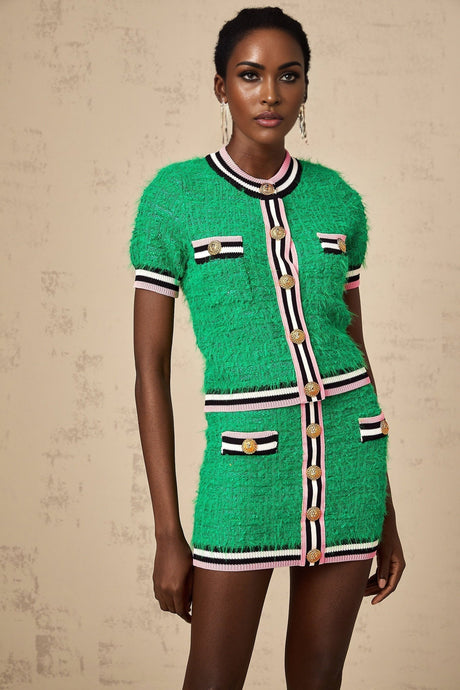 Woman wearing a green knitted top and matching skirt set called Camille standing against a plain background