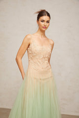 Woman wearing a green midi dress with lace panels and tulle skirt