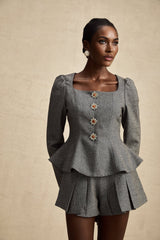 Woman wearing a grey herringbone pattern top with matching shorts set casual loungewear outfit