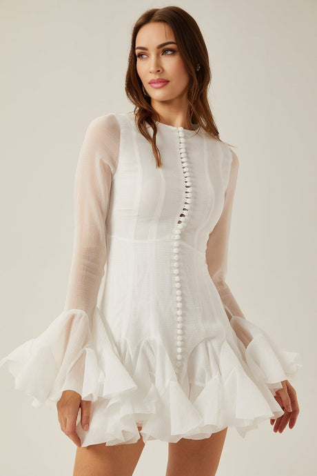 Woman wearing a light flowy semi sheer mini dress with flared skirt and short sleeves standing in relaxed pose