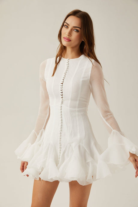 Woman wearing a light flowy short dress with semisheer fabric and flared skirt