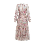 Woman wearing a lightcolored floral midi dress with ruffled details and tulle fabric standing in a neutral background