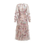 Woman wearing a lightcolored floral midi dress with ruffled details and tulle fabric standing in a neutral background