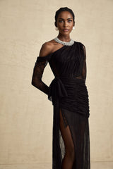 Woman wearing a long black oneshoulder maxi dress with a cutout detail