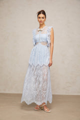 Woman wearing a long blue lace maxi dress with layered skirt and capucine neckline