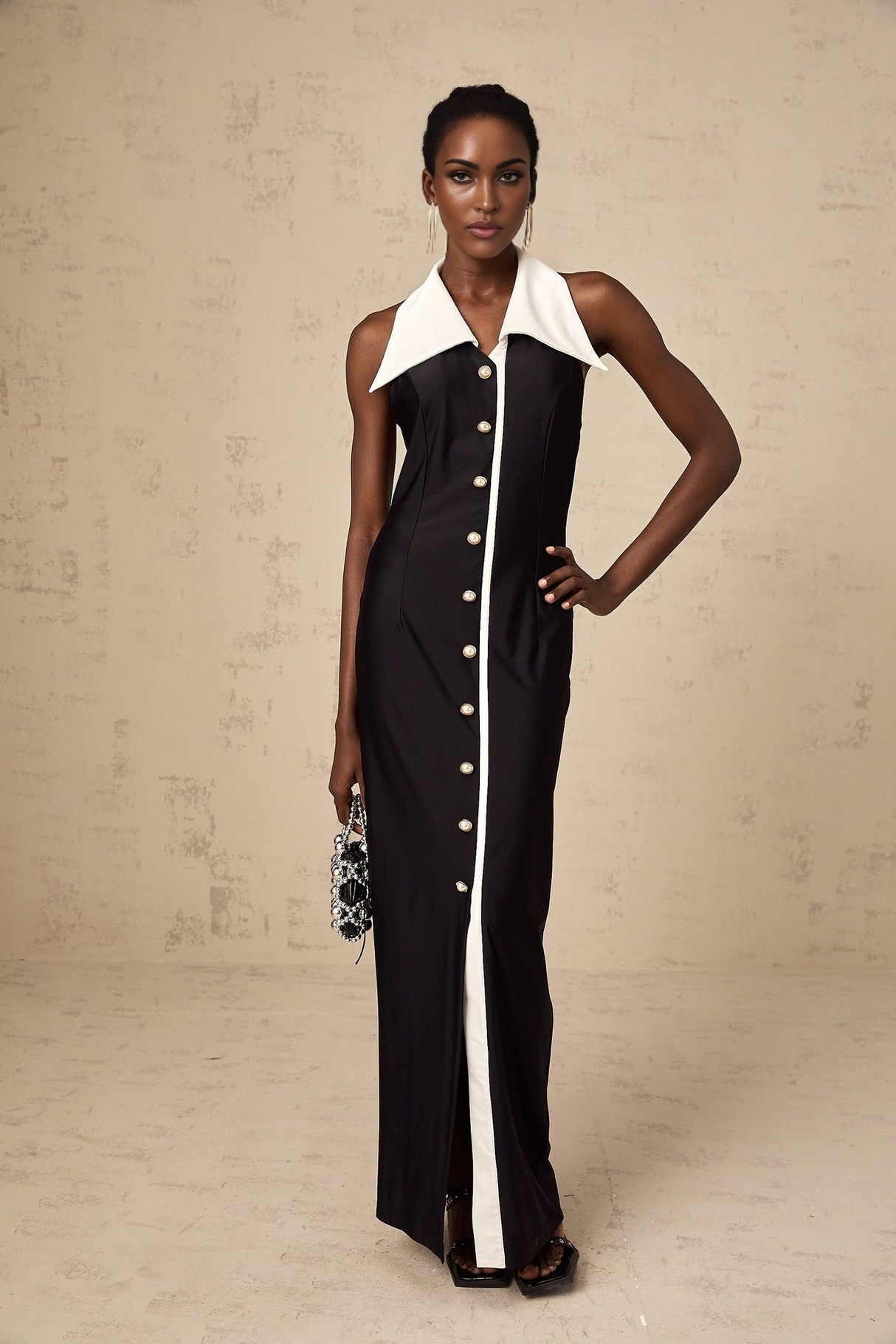 Woman wearing a long fitted maxi dress with colorblocked design featuring contrasting shades