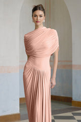Woman wearing a long pink asymmetric pleated maxi dress with flowing fabric and a fitted waist