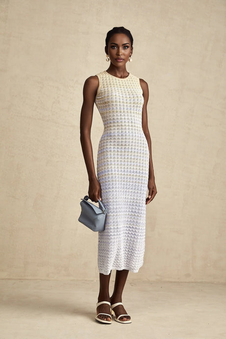 Woman wearing a long ribbed knit midi dress with contrasting color details