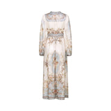 Woman wearing a long sleeve floral print bohemian style dress with a Camille design standing in a relaxed pose