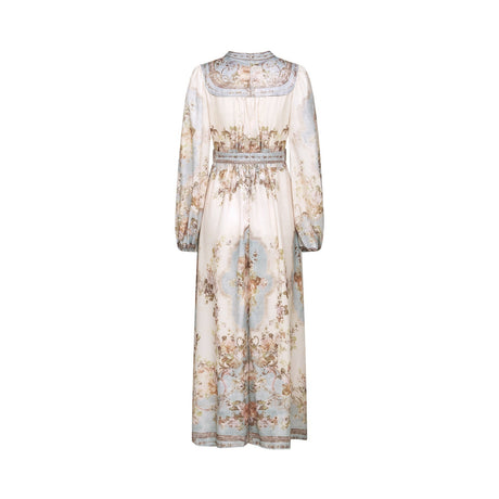 Woman wearing a long sleeve floral print bohemian style dress with a Camille design standing in a relaxed pose