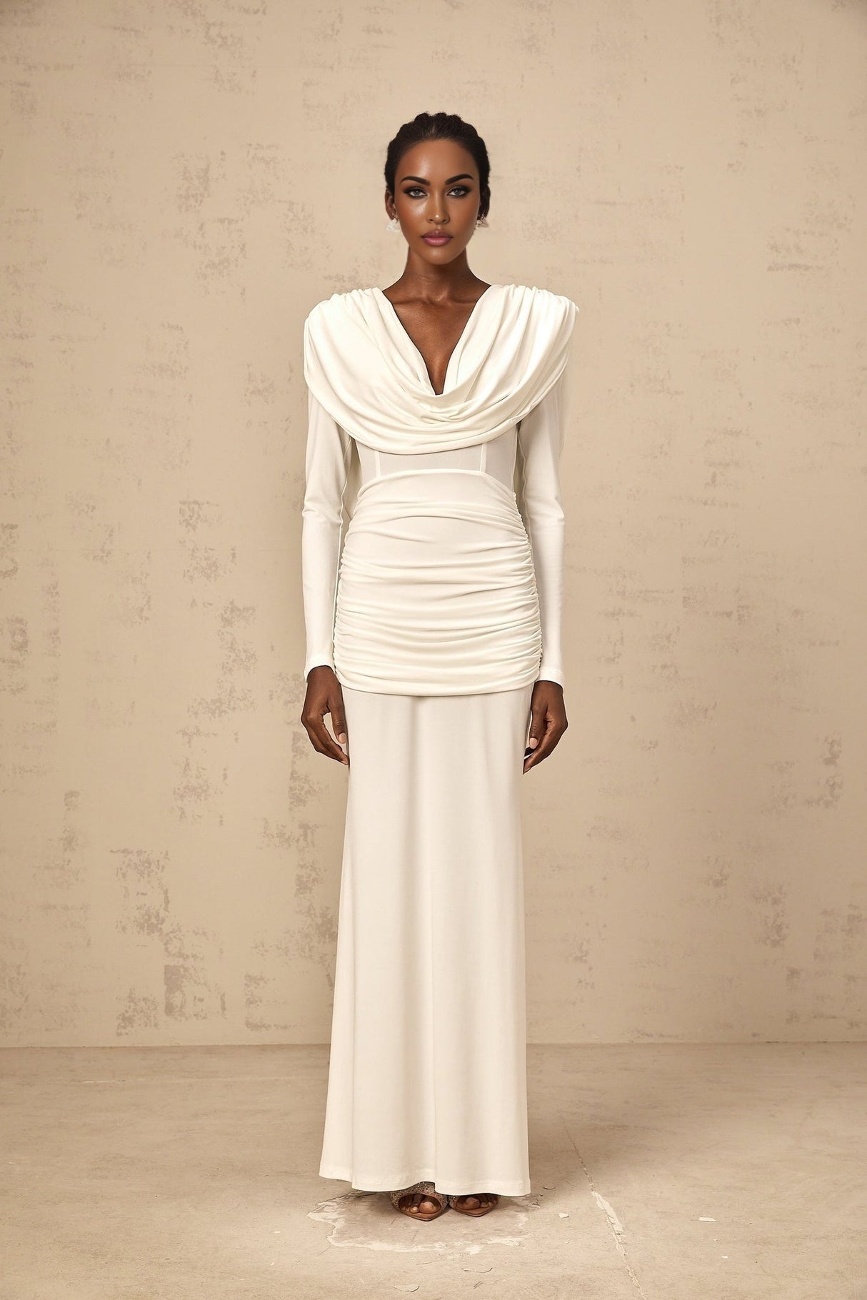 Woman wearing a long white fitted maxi dress with ruched detailing