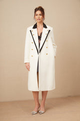Woman wearing a long wool blazer with color block design in shades of brown and beige double breasted style with lapels and pockets