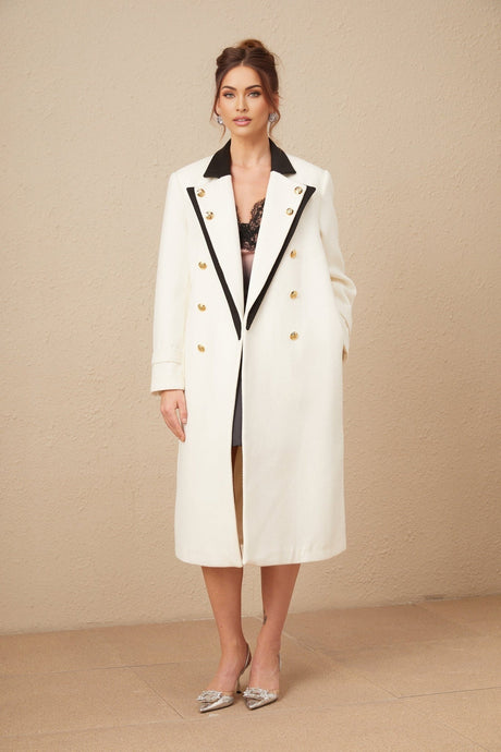 Woman wearing a long wool blazer with color block design in shades of brown and beige double breasted style with lapels and pockets