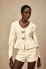 Woman wearing a matching crystalembellished jacket and shorts set in Iselin style