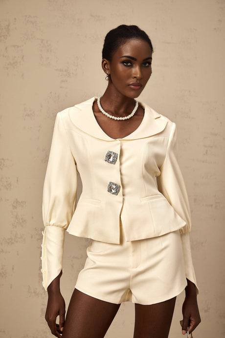 Woman wearing a matching crystalembellished jacket and shorts set in Iselin style