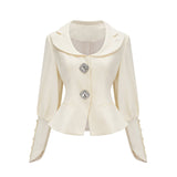 Woman wearing a matching jacket and shorts set embellished with crystal details The outfit has a glamorous and sparkly appearance