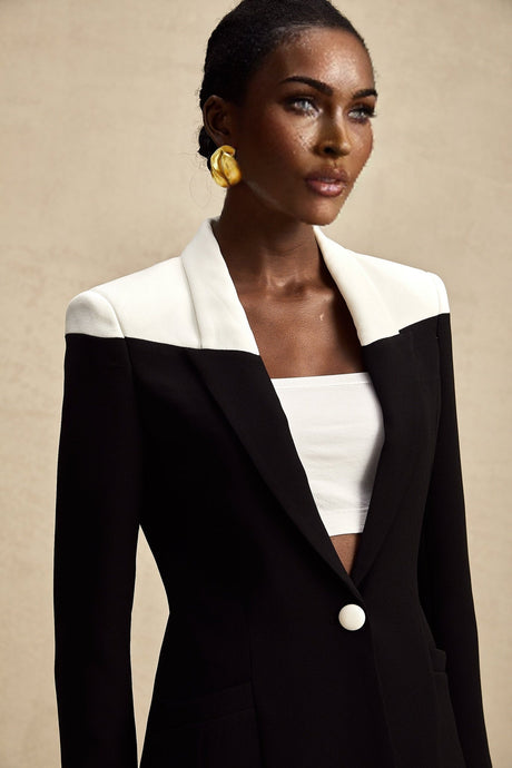 Woman wearing a matching jacket and skirt set with contrasting colors by Honorine