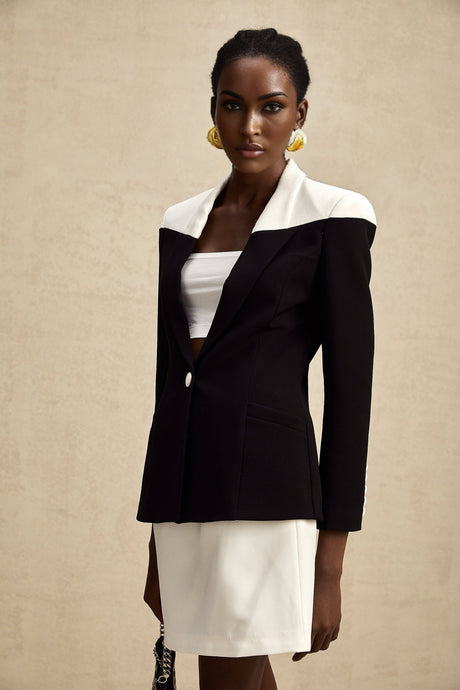 Woman wearing a matching jacket and skirt set with contrasting colors from Honorine