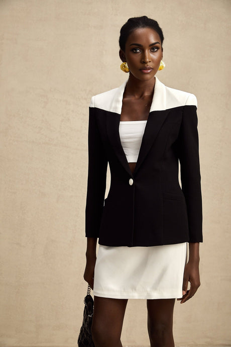 Woman wearing a matching jacket and skirt set with contrasting colors from the Honorine brand