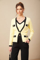 Woman wearing a matching knit set with cardigan vest and trousers featuring contrasting trim details in light colors