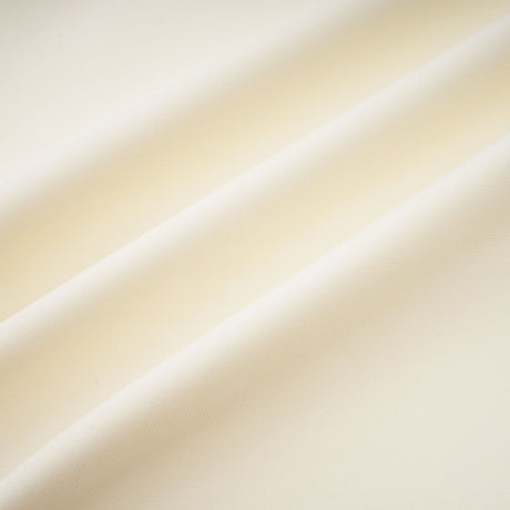 Woman wearing a matching set consisting of a top and skirt in neutral colors featuring threedimensional petal details
