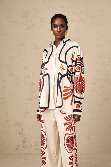 Woman wearing a matching set of shirt and trousers with colorful graphic print pattern
