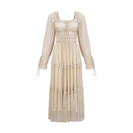 Woman wearing a metallic pleated midi dress with shirred details and a flowy silhouette named Camille