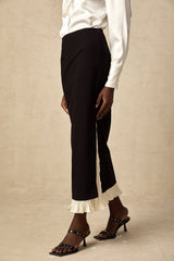 Woman wearing a midi length skirt with color block design and panels in contrasting colors