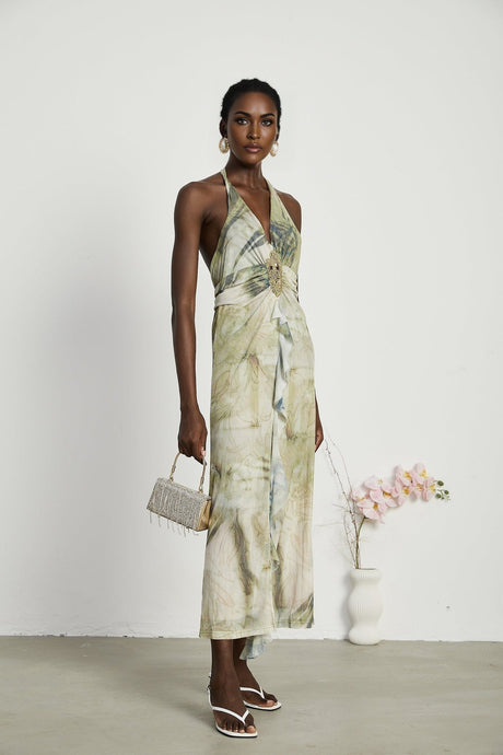 Woman wearing a midlength ombre print dress with neckholder design in flowing fabric
