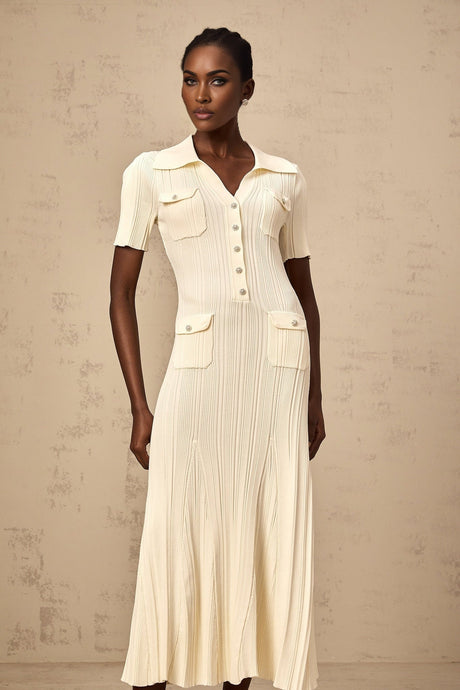 Woman wearing a neutralcolored ribbed knit midi dress with long sleeves and a formfitting silhouette