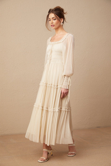 Woman wearing a pleated metallic midi dress with shirred detailing named Camille