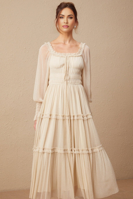 Woman wearing a pleated metallic midi dress with shirred detailing named Camille