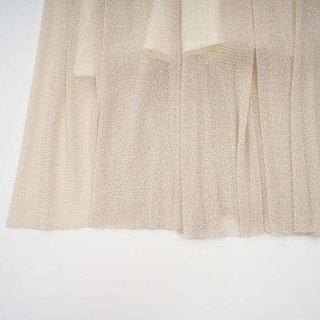 Woman wearing a pleated metallic midi dress with shirred detailing named Camille