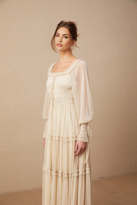 Woman wearing a pleated metallic midi dress with shirred detailing named Camille